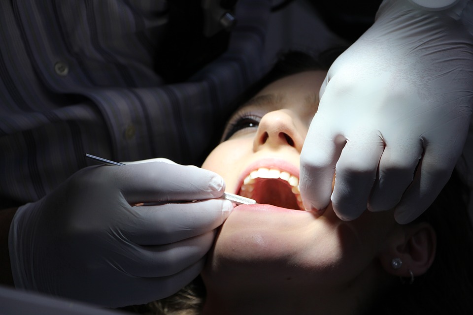 Dentist cleans woman's teeth. 